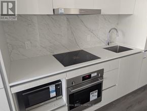 Vaughan (Vaughan Corporate Centre) condo for rent - A modern kitchen with a stainless steel oven and microwave.