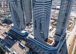 Vaughan (Vaughan Corporate Centre) condo for rent - A view of a city with tall buildings and a busy street below.