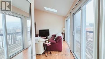 Barrie (City Centre) apartment for rent - A living room with a red chair and a white sofa.
