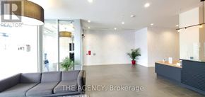 Mississauga (Central Erin Mills) condo for rent - A realtor office with a grey couch and a reception desk.