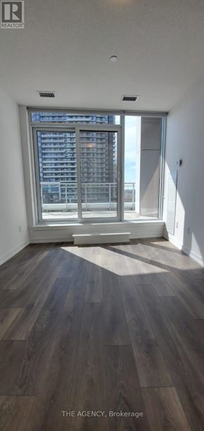 Mississauga (Central Erin Mills) condo for rent - A room with wooden flooring and a large window.