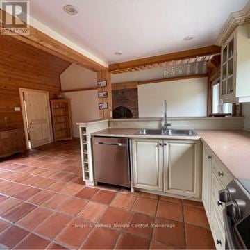 Blue Mountains apartment for rent - A modern kitchen with white cabinets and black countertops.