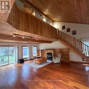 Blue Mountains apartment for rent - A large open living room with wood floors and a staircase.