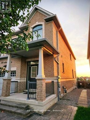 Vaughan (Vellore Village) townhouse for rent - A house with a front porch and a sign that says "Bay Street Group Inc. Brokerage".