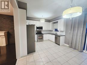 Vaughan (Vellore Village) townhouse for rent - A kitchen with white cabinets and a refrigerator.