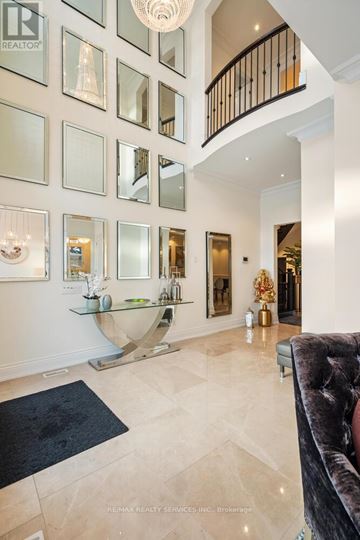 Brampton (Credit Valley) apartment for rent - A living room with a black couch and a chandelier.