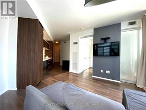 Toronto (Church-Yonge Corridor) condo for rent - A living room with a grey couch and a flat screen TV.