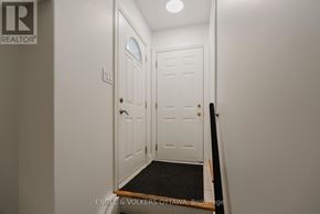 Ottawa apartment for rent - A white door with a black mat in front of it.