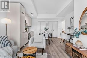 Toronto (Parkwoods-Donalda) townhouse for rent - A modern living room with a dining area and kitchen in the background.