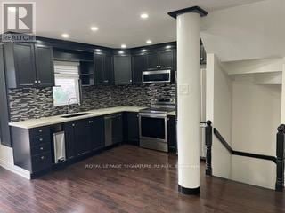 Whitby (Pringle Creek) townhouse for rent - A modern kitchen with dark wood cabinets and a white island.