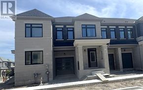 Markham (Middlefield) townhouse for rent - A modern two-story house with a flat roof and large windows.