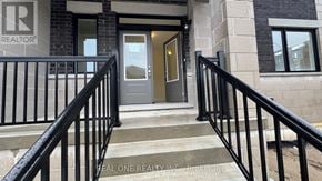 Markham (Middlefield) townhouse for rent - A set of stairs with a black railing leading to a door with a glass window.