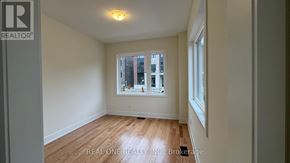 Markham (Middlefield) townhouse for rent - A room with a window and wooden flooring.