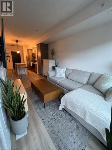 Burlington condo for rent - A living room with a grey couch and a wooden coffee table.