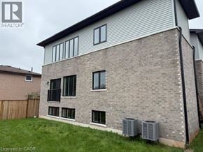 Hamilton apartment for rent - A house with a grey brick exterior and a white window.