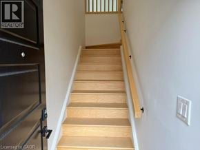 Hamilton apartment for rent - A staircase with wooden steps and a black railing.