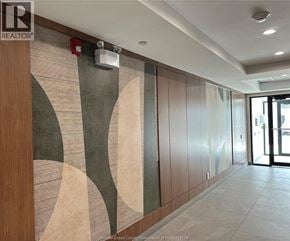 Windsor condo for rent - A hallway with a wooden wall and a mural on it.
