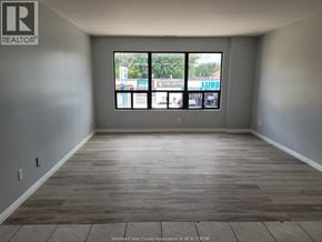 Windsor apartment for rent - A room with a large window and wooden flooring.