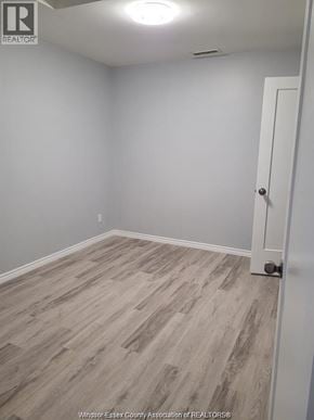Windsor apartment for rent - A room with a white door and grey flooring.