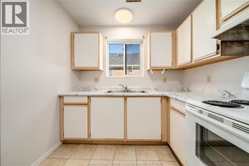 Windsor apartment for rent - A kitchen with white cabinets and a white stove top oven.