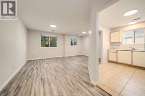 Windsor apartment for rent - A spacious room with wooden flooring and a large window.