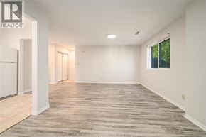 Windsor apartment for rent - A spacious room with wooden flooring and white walls.