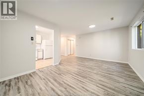 Windsor apartment for rent - A spacious room with wooden flooring and white walls.