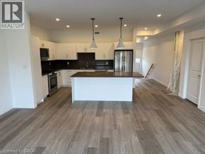 Hamilton apartment for rent - A spacious kitchen with a central island and pendant lights.