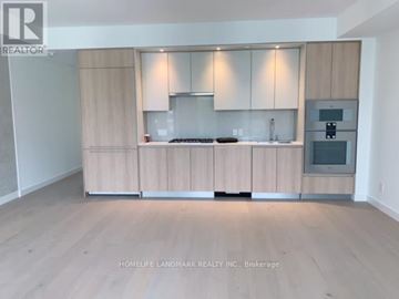 Toronto (Church-Yonge Corridor) condo for rent - A kitchen with wooden cabinets and a stove top oven.