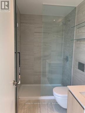 Toronto (Church-Yonge Corridor) condo for rent - A glass shower stall in a bathroom with a white toilet.