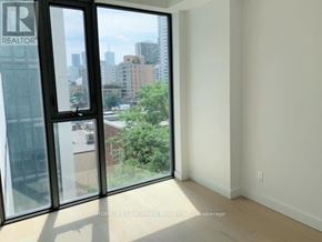 Toronto (Church-Yonge Corridor) condo for rent - A room with a view of the city through large windows.