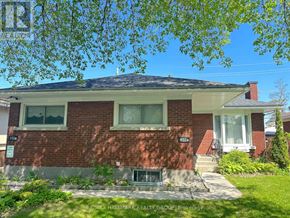 Ottawa apartment for rent - A red brick house with a white window and a small porch.