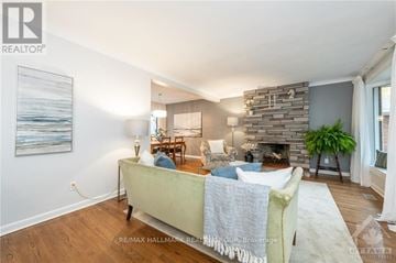 Ottawa apartment for rent - A living room with a stone fireplace and a painting on the wall.