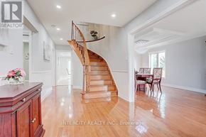 Richmond Hill (Devonsleigh) apartment for rent - A wooden staircase in a spacious room with a dining table set up.