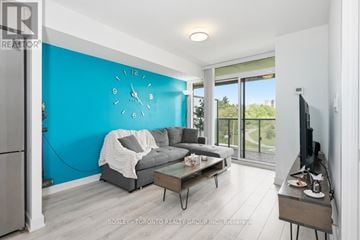 Toronto (Yorkdale-Glen Park) condo for rent - A living room with a grey couch and a blue wall.
