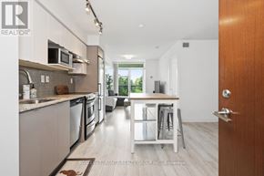 Toronto (Yorkdale-Glen Park) condo for rent - A modern kitchen with a dining area in the background.