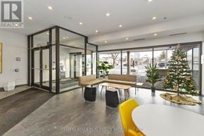 London East (East F) condo for rent - A modern office space with a glass wall and a Christmas tree.