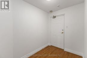 London East (East F) condo for rent - A white door is in a white room with wood floors.
