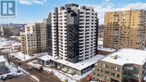 London East (East F) condo for rent - A tall building with the word TEAM GLA on it stands in the middle of a snowy street.