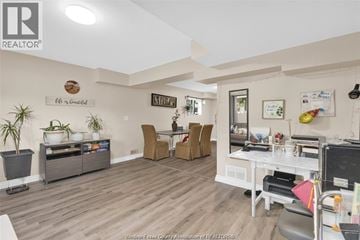 Windsor duplex for rent - A living room with a white couch and a wooden floor.