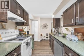 Windsor duplex for rent - A kitchen with white appliances and brown cabinets.