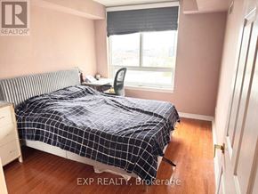 Toronto (Bayview Village) condo for rent - A bedroom with a bed, desk, and window.