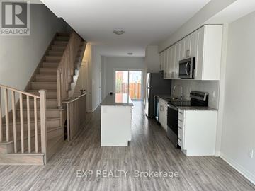 Oshawa (Samac) apartment for rent - A kitchen with white cabinets and a staircase.