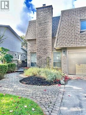 Markham (Unionville) apartment for rent - A house with a grey garage door and a stone wall.