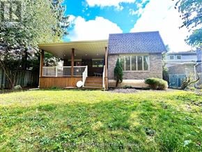 Markham (Unionville) apartment for rent - A house with a wooden deck and a stone wall.