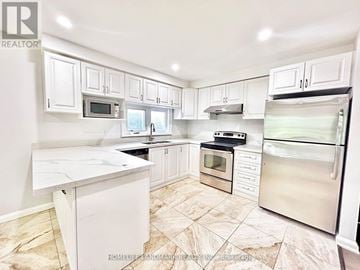 Markham (Unionville) apartment for rent - A kitchen with white cabinets and appliances.