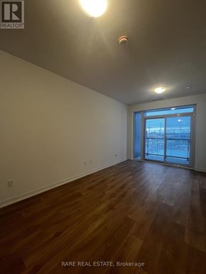 Vaughan (Concord) condo for rent - A room with wood flooring and a sliding glass door.