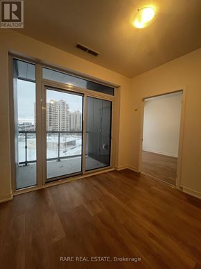 Vaughan (Concord) condo for rent - A room with a sliding glass door and wooden flooring.
