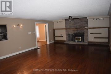 Uxbridge apartment for rent - A living room with a fireplace and a tv on the wall.