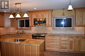 Uxbridge apartment for rent - A kitchen with wooden cabinets and granite countertops.